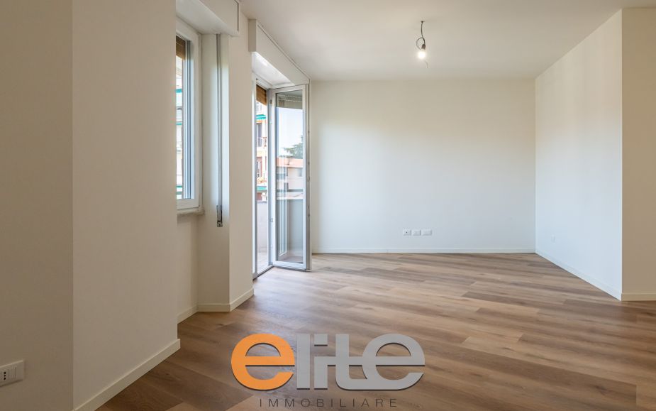 The apartment opens onto a living room with a brand-new, never-used open-plan kitchen