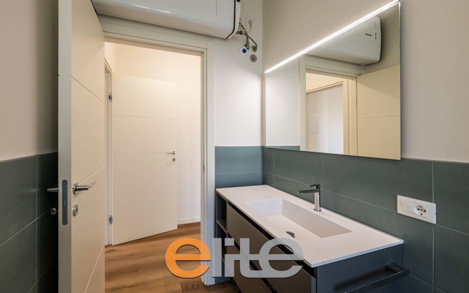 The apartment opens onto a living room with a brand-new, never-used open-plan kitchen