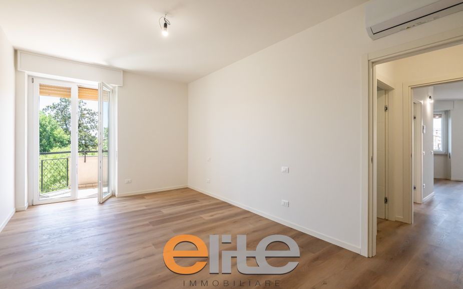 The apartment opens onto a living room with a brand-new, never-used open-plan kitchen