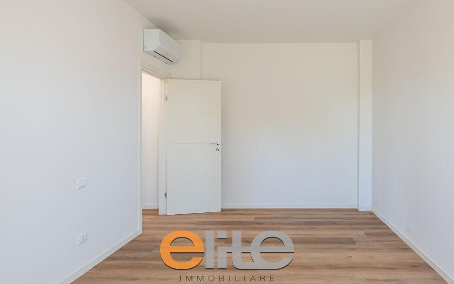 The apartment opens onto a living room with a brand-new, never-used open-plan kitchen